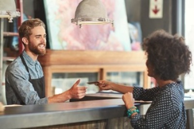 Image of a person using a debit card